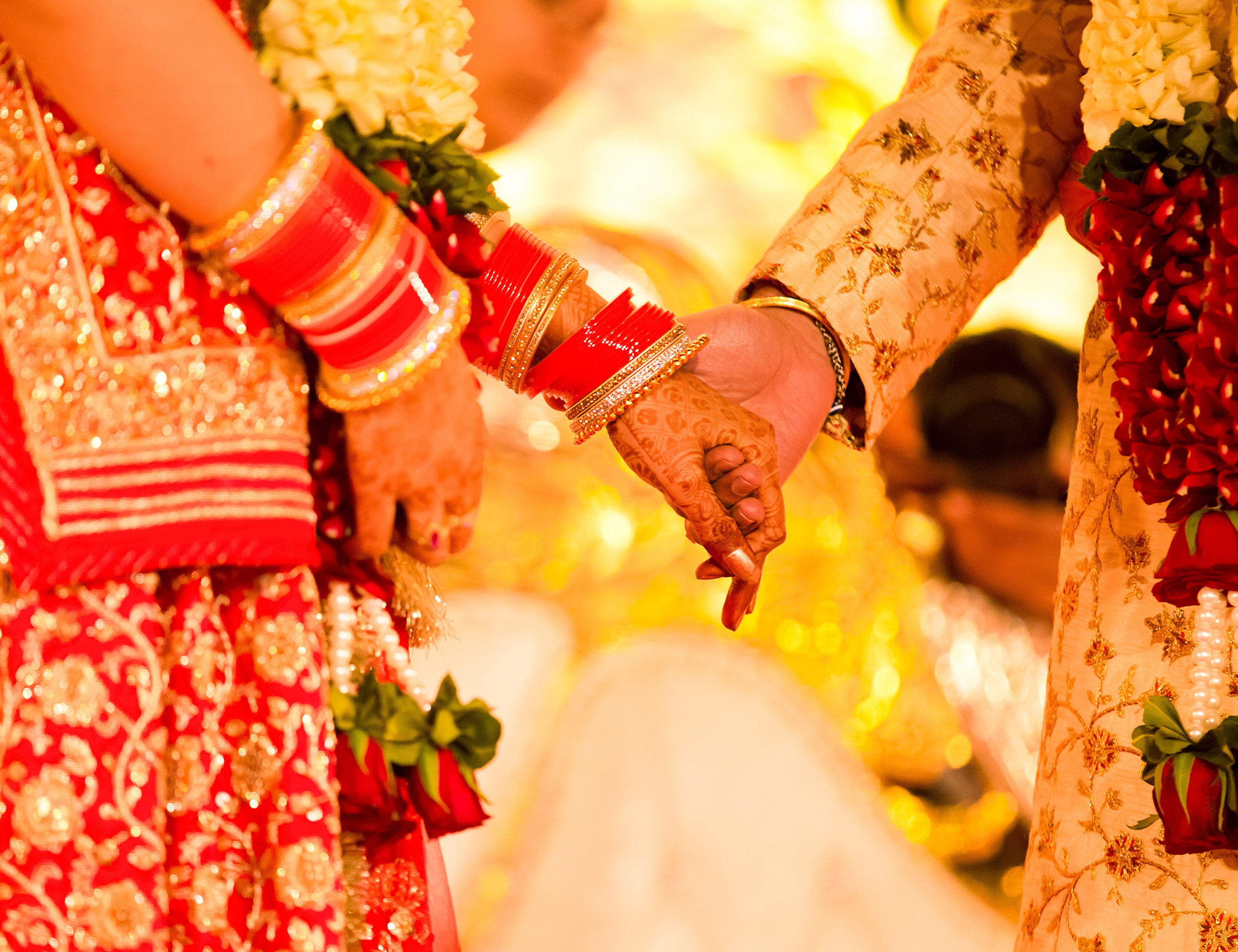 Bride and groom taking pheras around the sacred fire in a traditional wedding ceremony.
